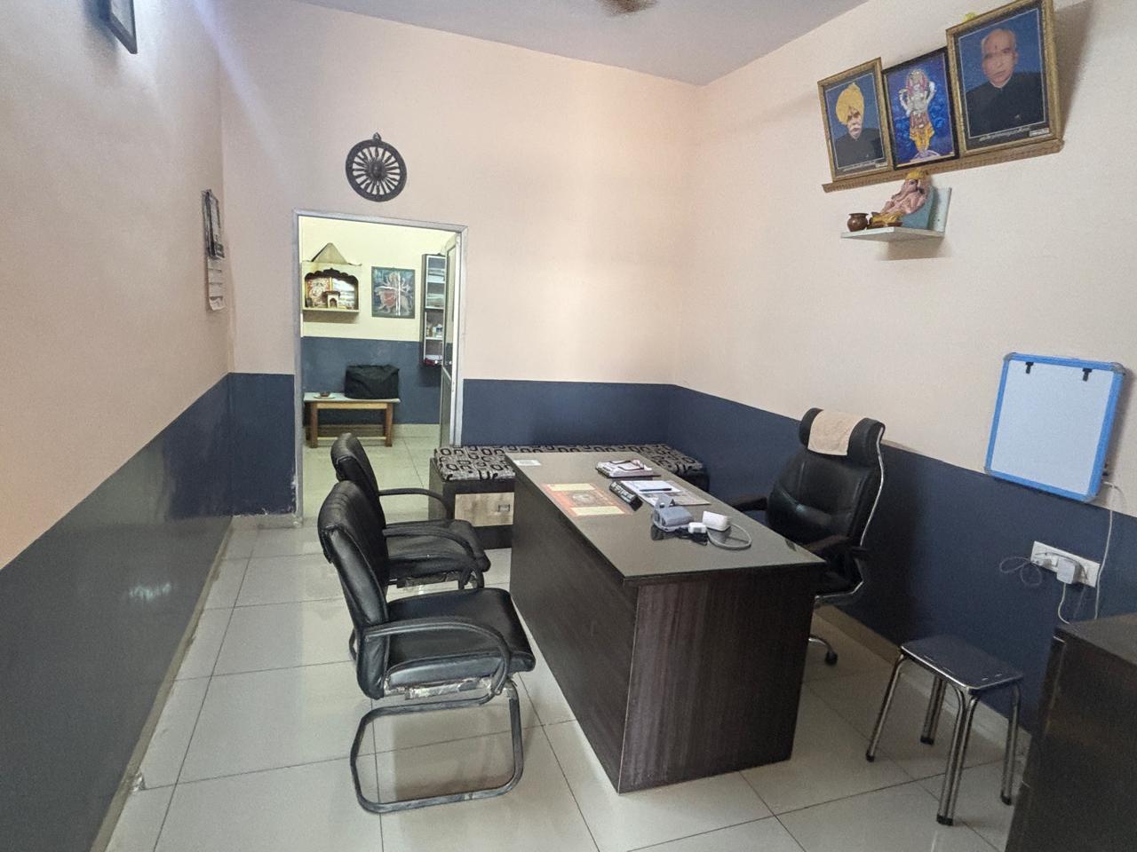 Doctor's consultation room with ancestral portraits